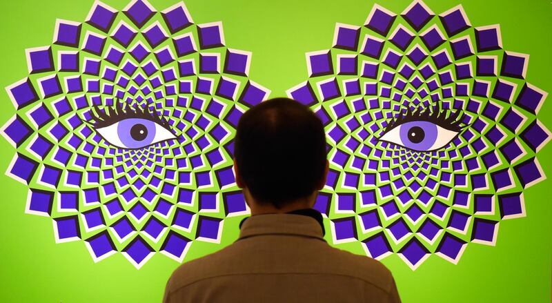 A visitor examines an optical illusion which is part of the interactive experience exhibition 'Tricked!'' at Augustusburg castle in Germany. AP