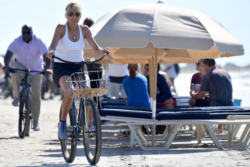 First lady Jill Biden rides her bicycle along the beach while on vacation on Kiawah Island. AFP