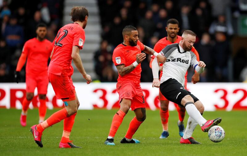 Wayne Rooney surrounded by Huddersfield Town players during the Championship match at Pride Park on February 15.