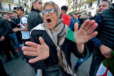 TOPSHOT - An Algerian woman chants slogans as she takes part in an anti-government demonstration in the capital Algiers on December 12, 2019 during the presidential election. Five candidates are running in Algeria's presidential election to replace ousted Algerian president Abdelaziz Bouteflika, the country's election authority said Saturday, amid widespread protests against the vote. Former premiers Ali Benflis and Abdelmadjid Tebboune are considered front-runners in an election opposed by the mass protest movement that alongside the army forced Bouteflika to resign in April after 20 years in power.

No opinion polls have been published but observers expect an extremely low turnout nationwide after months of demonstrations opposing the vote.
 / AFP / RYAD KRAMDI                        
