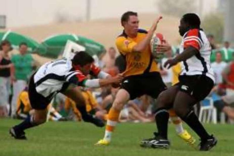 

DUBAI, UNITED ARAB EMIRATES – Sep 19:  James Tometzki ( from Dubai Hurricanes in yellow with ball) in action during the rugby match between Dubai Hurricanes (yellow) vs Dubai Dragons (white) at new rugby ground on  Dubai Al Ain road. Dubai Dragons won the match by 13-0. (Pawan Singh / The National) *** Local Caption ***  PS006- RUGBY.jpg