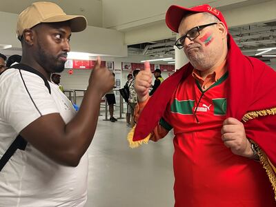 Australian-Somali football fan Abdi Gamadid, left, and Moroccan supporter Filali Said after the Morocco versus Belgium match in Doha. Saeed Saeed / The National