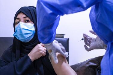 Aysha Ali receives the first of two Sinopharm vaccine jabs at Burjeel Hospital in Abu Dhabi. Victor Besa / The National