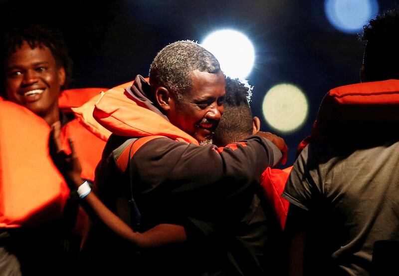 Rescued migrants embrace as they arrive on an Armed Forces of Malta patrol boat in Valletta's Marsamxett Harbour, Malta. Reuters