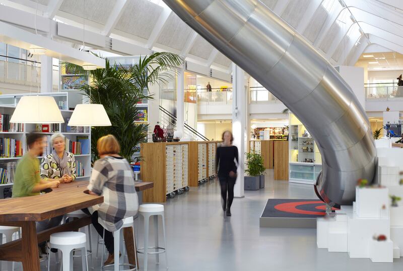Lego's office in Denmark has an open floor plan with bright furniture and a curved metal slide. Photo: Pinterest