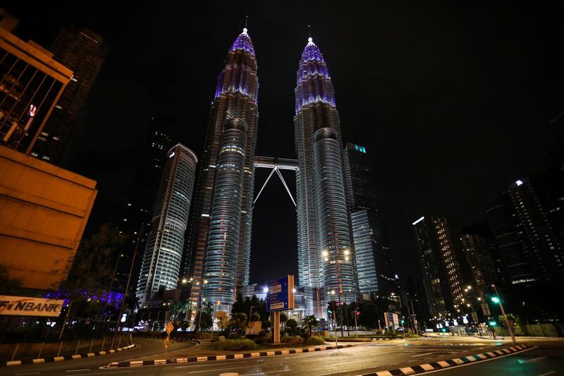 Kuala Lumpur's Petronas Twin Towers are seen illuminated in blue as part of the “Light It Blue” initiative to honour front-line workers. Reuters
