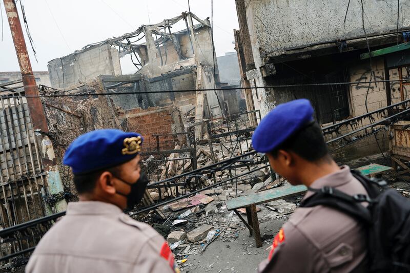 Police stand guard at the scene of a deadly fire at a fuel storage station in Jakarta, Indonesia. Reuters