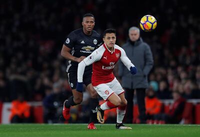 Soccer Football - Premier League - Arsenal vs Manchester United - Emirates Stadium, London, Britain - December 2, 2017   Arsenal's Alexis Sanchez in action with Manchester United's Antonio Valencia    Action Images via Reuters/Andrew Couldridge    EDITORIAL USE ONLY. No use with unauthorized audio, video, data, fixture lists, club/league logos or "live" services. Online in-match use limited to 75 images, no video emulation. No use in betting, games or single club/league/player publications. Please contact your account representative for further details.