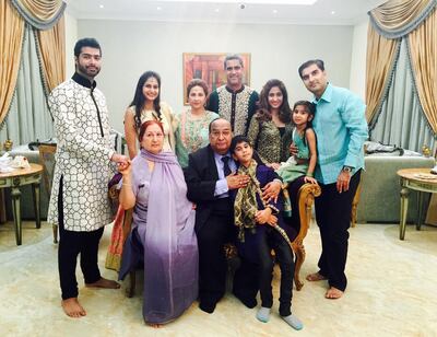 Vasu Shroff, seated, chairman of the Regal Group, in a family photo during the Diwali festival in 2015. His grandson Krish, left, convinced him to write a book about his life in Dubai. Courtesy: Shroff family