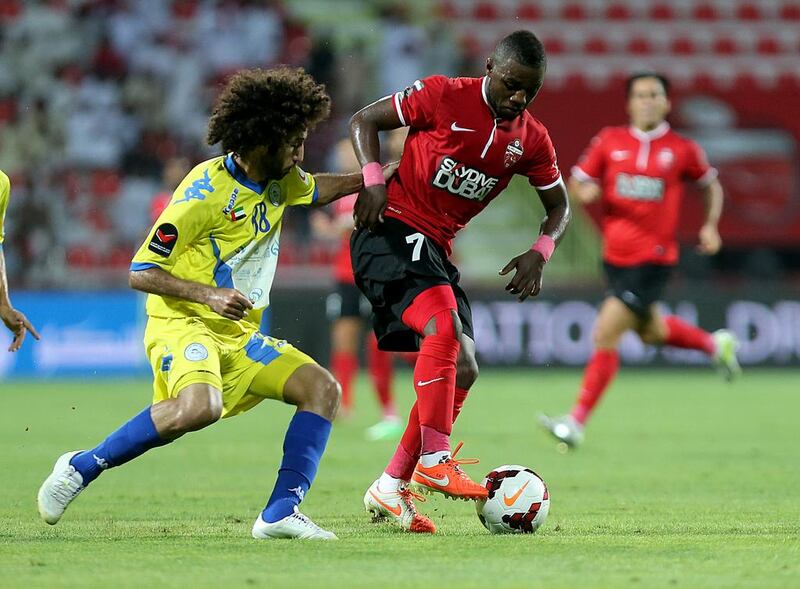 Ismail Al Hamadi of Al Ahli, right, and Abdalla Al Naqbi of Al Dhafra in action during their Arabian Gulf League contest on Sunday. Satish Kumar / The National