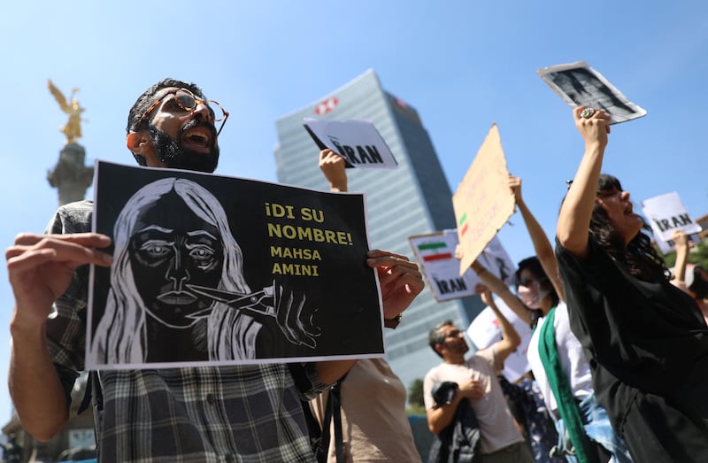 Demonstrators hold placards in Mexico City during a protest against Iran. Reuters