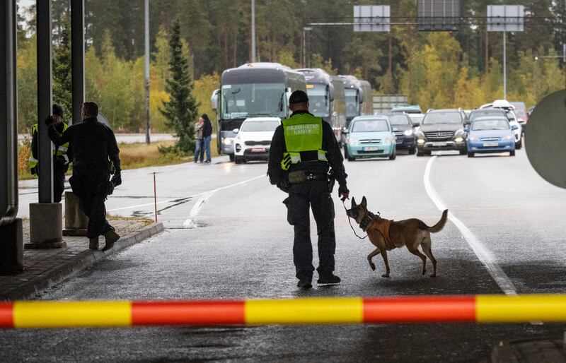 A Finnish guard patrols with his dog in Vaalimaa, Finland, at the border with Russia.