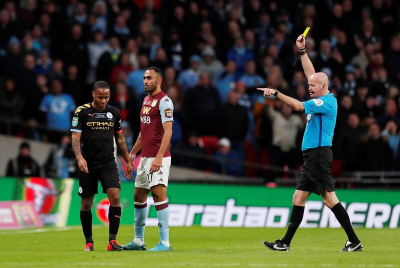 Manchester City's Raheem Sterling is shown a yellow card by referee Lee Mason. Reuters