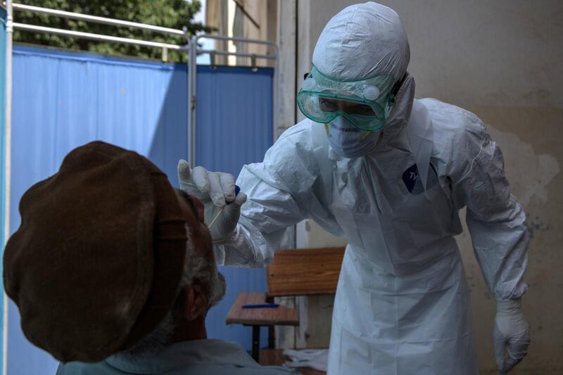 A man suspected to be infected with the coronavirus gets tested at Taloqan's coronavirus hopsital. 