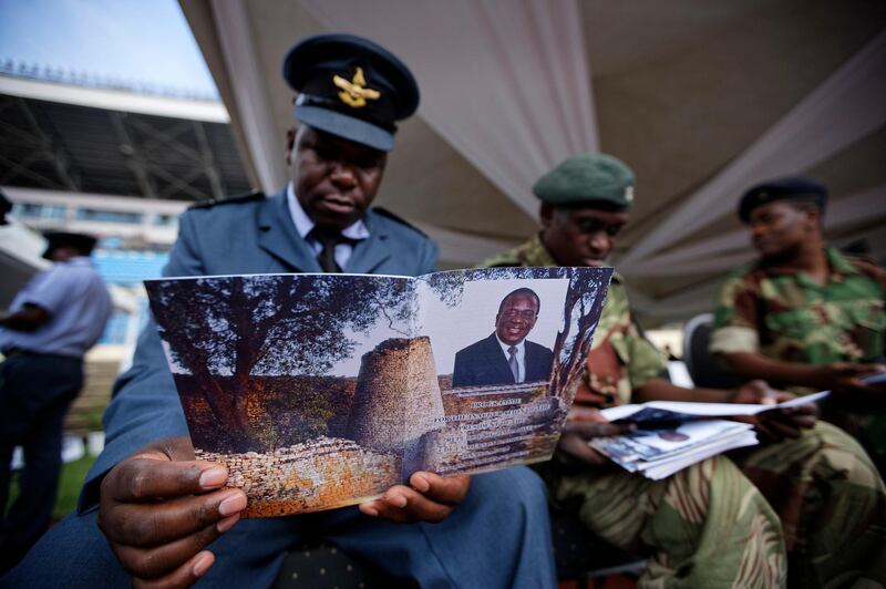 A Zimbabwe Air Force officer reads the inauguration programme. Ben Curtis / AP Photo