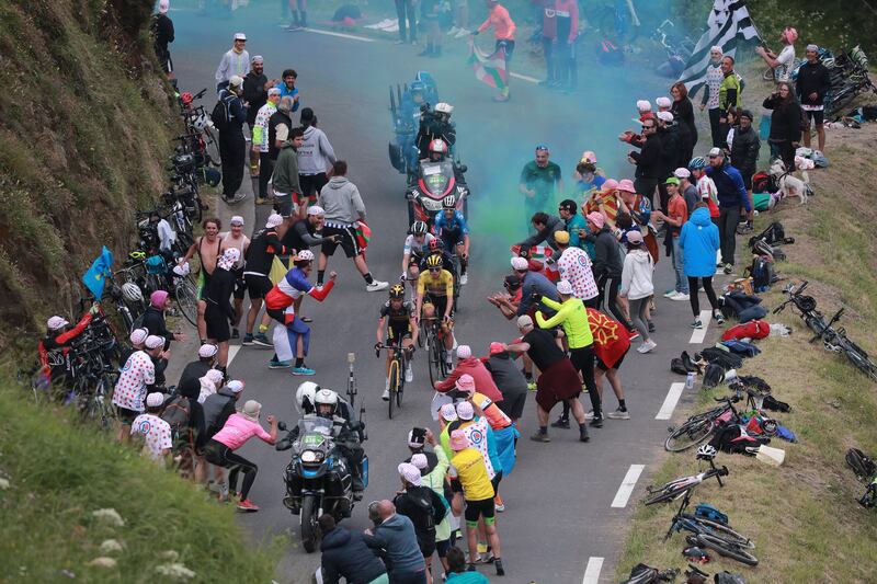 Spectators cheer on race leader Tadej Pogacar, of the UAE-Team Emirates, during Stage 18 on Thursday, July 15.