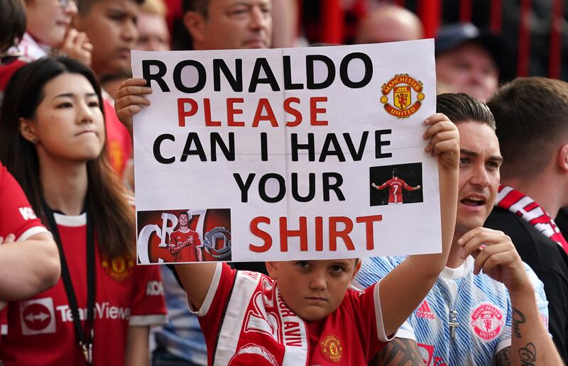 Fans brandish a Cristiano Ronaldo sign during the game at Old Trafford. PA