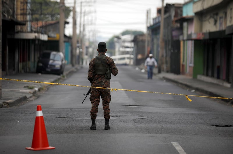 A soldier stands at a checkpoint during a joint operation by police and army, as part of security measures to keep people out of the city downtown during a quarantine throughout the country to curb the spread of the coronavirus disease (COVID-19), in San Salvador, El Salvador. REUTERS