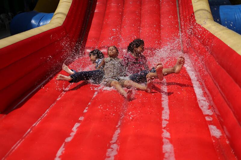 Palestinian children slide down an inflatable  in Gaza City.  Reuters