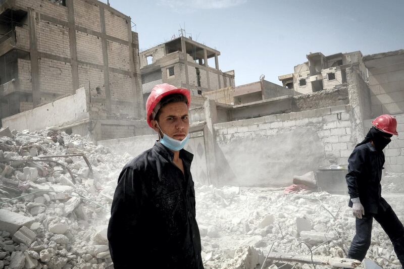 <p>Exahusted firemen in the rubble of bomb blasted Raqqa. Photo: David Pratt for The National