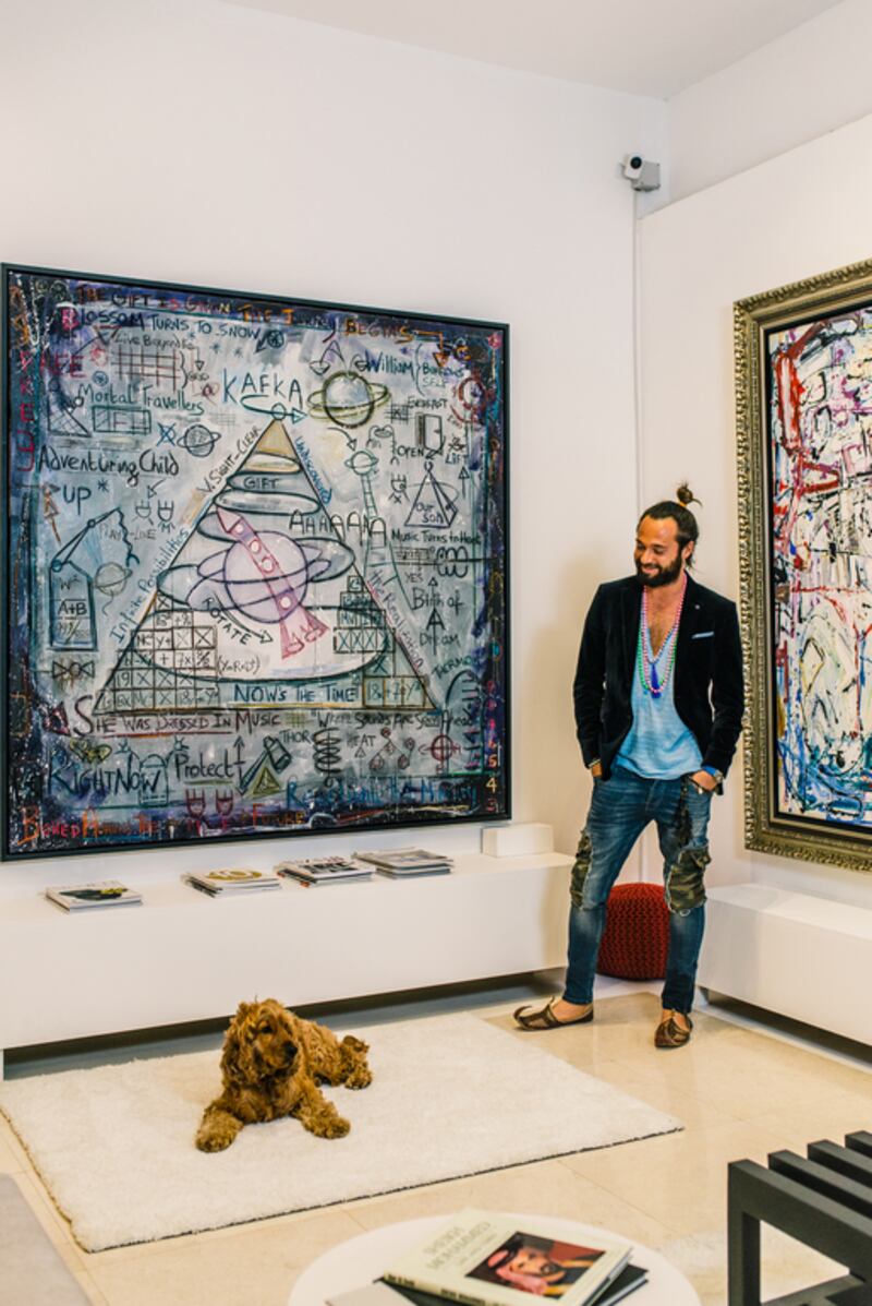 British-Indian artist Sacha Jafri next to two of his works at his home studio on Palm Jumeirah in Dubai. Alex Atack for The National 