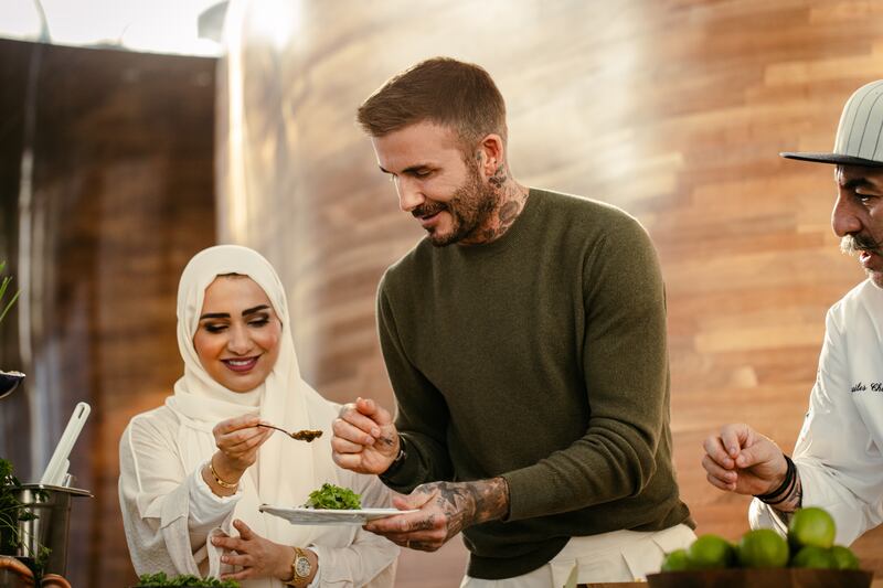 David Beckham cooking with Qatari chef Noor Al Mazroei.