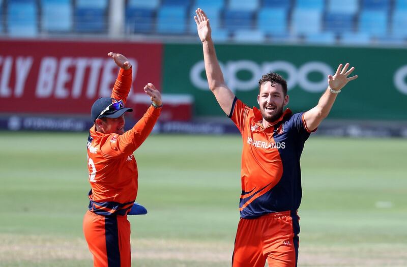 DUBAI, UNITED ARAB EMIRATES , October 29  – 2019 :- Paul van Meekeren of Netherlands ( right ) celebrating after taking the wicket of Rameez Shahzad during the World Cup T20 Qualifier between UAE vs Netherlands held at Dubai International Cricket Stadium in Dubai.  ( Pawan Singh / The National )  For Sports. Story by Paul