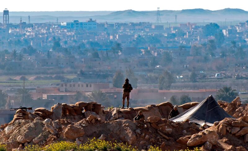 A fighter with the Syrian Democratic Forces keeps watch in the Baghouz area in Deir Ezzor during an operation to expel ISIS forces from the region. AFP