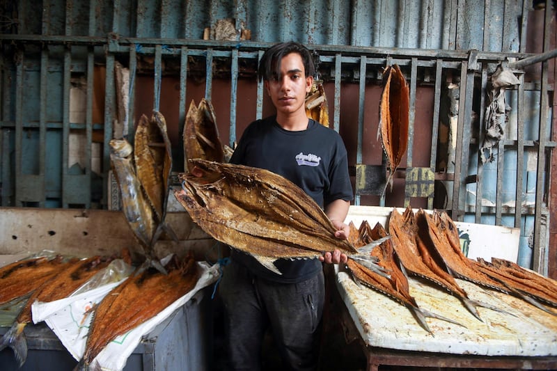 A man poses with Basra dried fish masmouta, at a market in the Iraqi city. Reuters