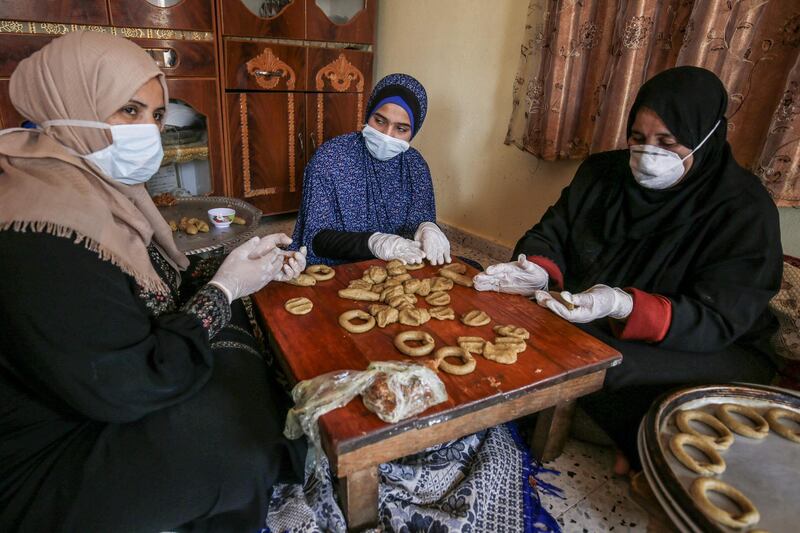 Palestinian women make traditional biscuits in preparation for the upcoming Eid Al Fitr holiday in Rafah, Gaza Strip. AFP