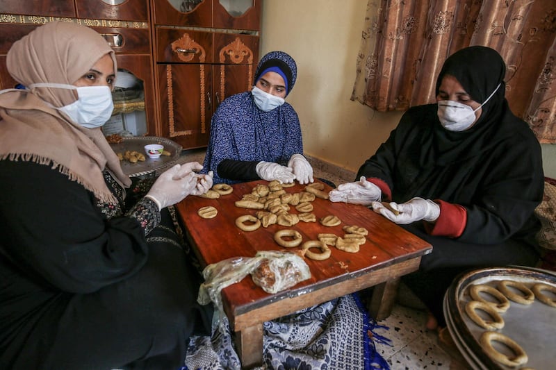 Palestinian women make traditional biscuits in preparation for the upcoming Eid Al Fitr holiday in Rafah, Gaza Strip. AFP