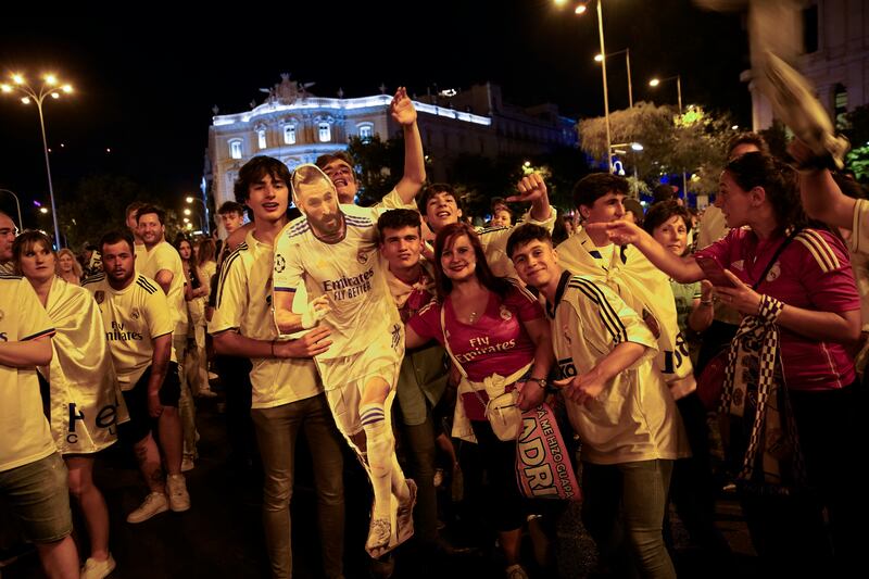 Real Madrid supporters celebrate with a cut-out of striker Karim Benzema. AP