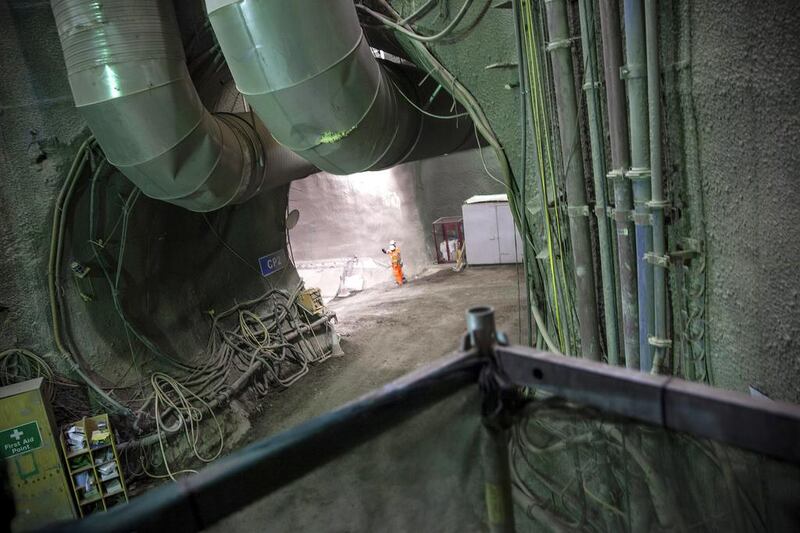 Workers wait in a tunnel after a Crossrail tunelling machine broke through into the Whitechapel station. Dan Kitwood / Getty Images