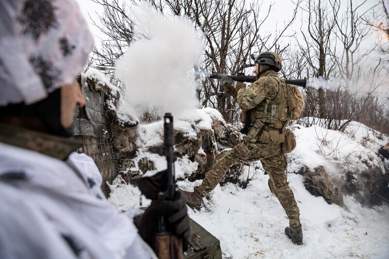 A member of Ukraine's 79th Air Assault Brigade fires a rocket-propelled grenade at Russian positions near Marinka in February 2023. Reuters
