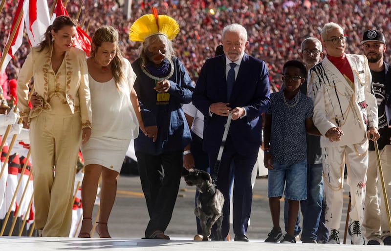 Brazil's President Luiz Inacio Lula da Silva, with his wife Rosangela da Silva, left, lead supporters after his swearing-in ceremony. Reuters