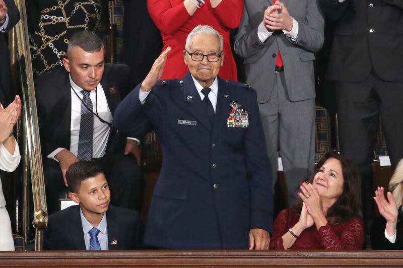 Retired US Air Force Col. Charles McGee, who served with the Tuskagee Airmen, salutes during the State of the Union address with his great- grandson Iain Lanphier in the chamber of the US House of Representatives in Washington, DC. Getty Images