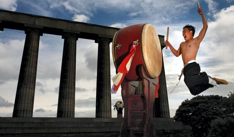 EDINBURGH, UNITED KINGDOM - AUGUST 01:  Dulsori drummers promote there Edinburgh festival show on top of Calton Hill August 1, 2007 in Edinburgh,Scotland.The Korean arts company based in the UK,present Binari:The Spirit of the Beat at this year festival.  (Photo by Jeff J Mitchell/Getty Images)