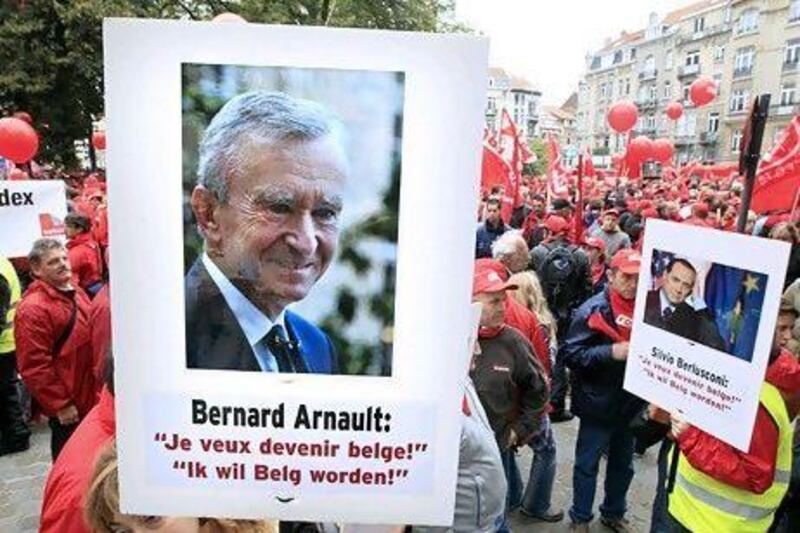 Belgian union workers protest against Bernard Arnault, the owner of the LVMH luxury goods group, after the Frech businessman was revealed to have applied for citizenship of Belgium, where the wealthy find the fiscal regime friendlier. Yves Herman / Reuters