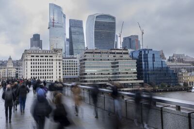 Commuters in view of skyscrapers in the City of London square mile financial district. Bloomberg 
