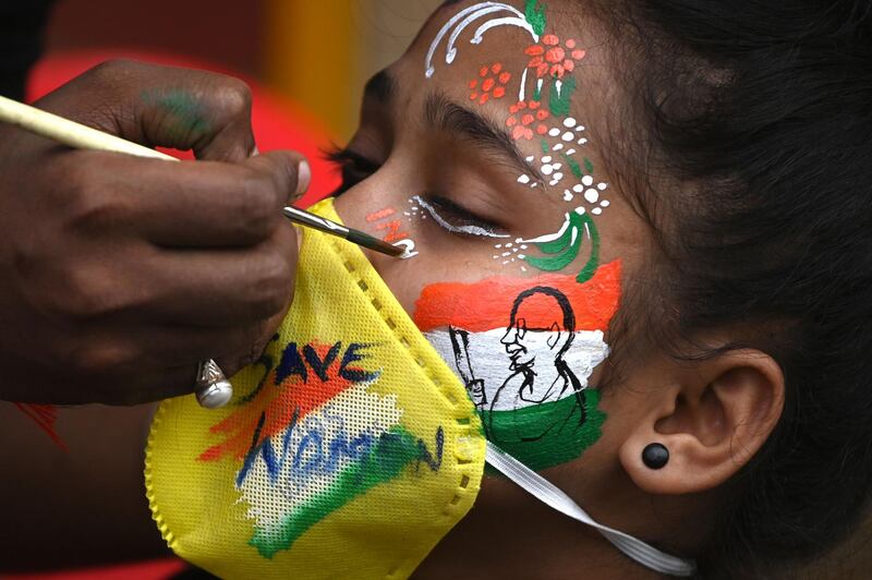 A student gets her face painted to condemn the alleged gang-rape of 19-year-old woman victim by four men in Bool Garhi village of Uttar Pradesh state, in Mumbai. AFP