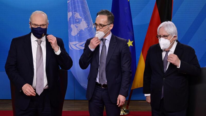 U.S. special envoy for Yemen Timothy Lenderking, German Foreign Minister Heiko Maas and UN Special Envoy for Yemen Martin Griffiths take off their face masks before adressing a news conference following talks at the Foreign Ministry in Berlin, Germany April 12, 2021. John MacDougall/Pool via REUTERS