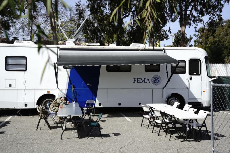 A US Army soldier rests outside a Federal Emergency Management Agency (FEMA) trailer at a mass vaccination site co-operated by FEMA and Cal OES in East Los Angeles, California. Bloomberg
