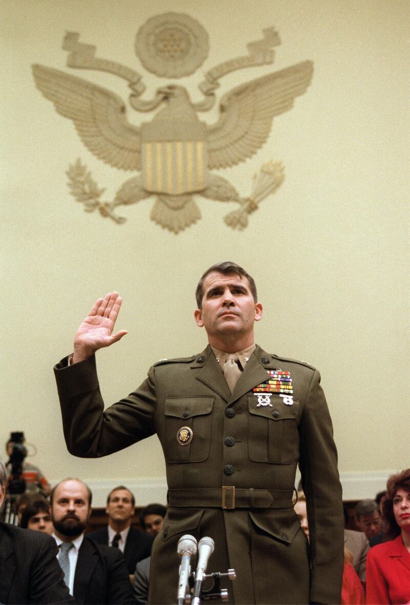 (FILES) In this file photo taken on December 9, 1986' Lieutenant-Colonel Oliver North is sworn in before the House Foreign Affairs Committee hearing in Washington, DC. 
North, a key figure in the Iran-Contra arms-for-hostages scandal under US president Ronald Reagan, is to become the next president of the National Rifle Association (NRA), the US gun lobby announced on May 7, 2018. / AFP PHOTO / CHRIS WILKINS