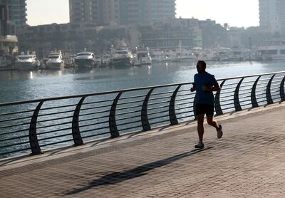Dubai, United Arab Emirates - December 26th, 2017: Standalone. A man jogs round the marina. Tuesday, January 2nd, 2018 at Marina, Dubai. Chris Whiteoak / The National