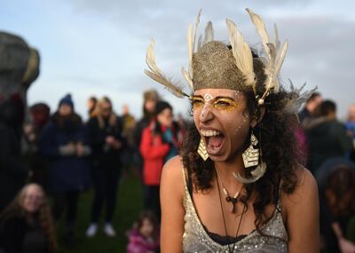 A woman celebrates after the winter solstice at Stonehenge, England, Dec. 22, 2018. Stonehenge, a United Nations Educational, Scientific and Cultural Organization World Heritage site, has been a place of worship and celebration during the winter and summer solstices for many generations. (U.S. Air Force photo by Airman 1st Class Madeline Herzog)