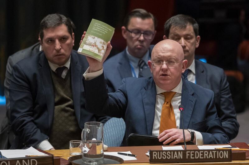 Russian Ambassador to the United Nations Vassily Nebenzia holds up a copy of "Alice's Adventures in Wonderland" as he speaks during a Security Council meeting on the situation between Britain and Russia Thursday, April 5, 2018 at United Nations headquarters. (AP Photo/Mary Altaffer)