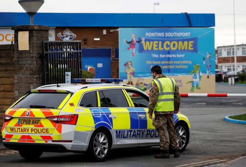 A soldier stands guard at the gate of the Pontins Southport Holiday Park while preparing to support Liverpool ahead of a mass testing. Reuters