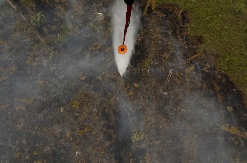 An MI-8MTV-1 helicopter from Indonesian National Disaster Management Agency carries water to dump on burning peatland forest in Pulang Pisau regency near Palangka Raya, Central Kalimantan province, Indonesia. Reuters