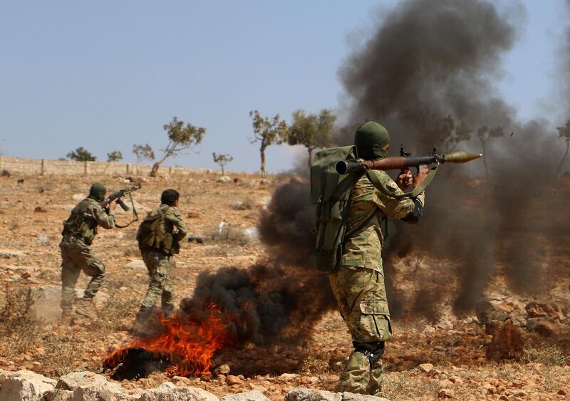 Syrian rebel fighters from the recently-formed "National Liberation Front" take part in combat training at an unknown location in the northern countryside of the Idlib province on September 11, 2018, in anticipation for an upcoming government forces offensive. - The Syrian regime and its Russian ally are threatening an offensive to retake the northwestern province of Idlib, Syria's last rebel bastion. (Photo by Aaref WATAD / AFP)