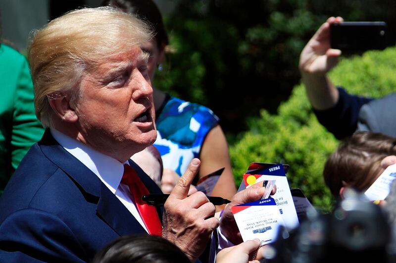 President Donald Trump is surrounded by children as he talks in the Rose Garden in celebration of "Bring Our Daughters and Sons to Work Day" at the White House in Washington, Thursday, April 26, 2018. (AP Photo/Manuel Balce Ceneta)